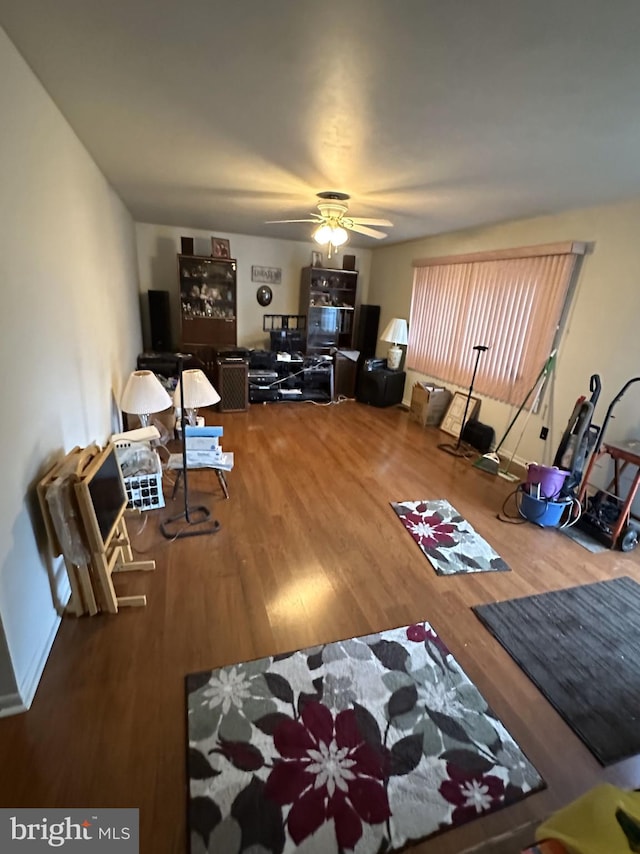 living room with hardwood / wood-style flooring and ceiling fan