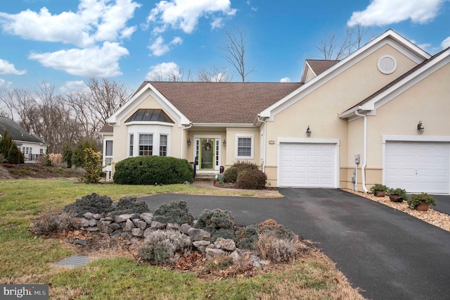 view of front of property with a garage and a front lawn