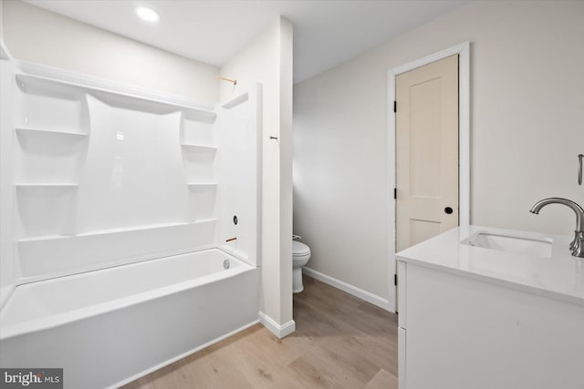 full bathroom featuring wood-type flooring, toilet, vanity, and  shower combination