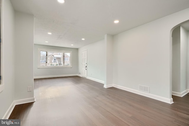 empty room featuring dark wood-type flooring