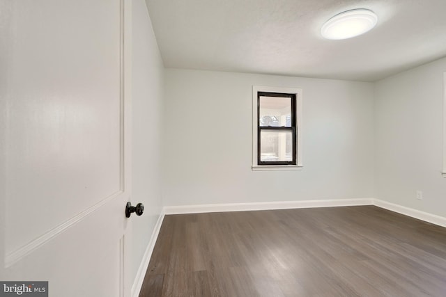 spare room featuring dark hardwood / wood-style flooring