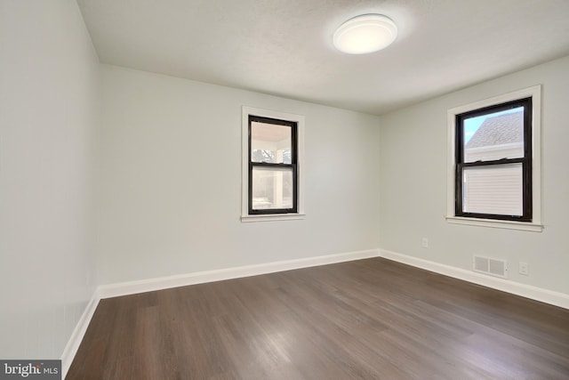 empty room featuring dark hardwood / wood-style flooring