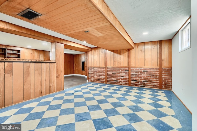 basement featuring brick wall and wood walls