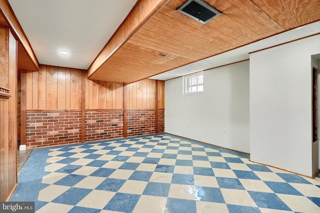 basement with brick wall, wood walls, and wood ceiling