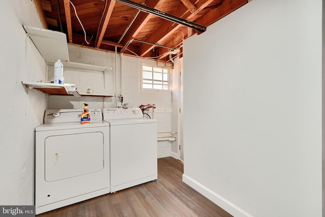 laundry area featuring light wood-type flooring and separate washer and dryer