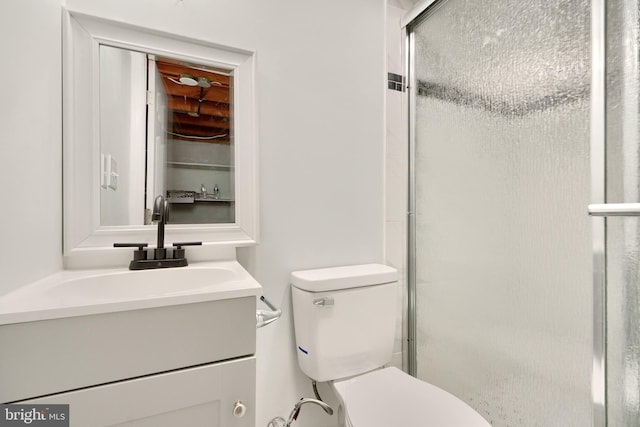 bathroom featuring walk in shower, vanity, and toilet