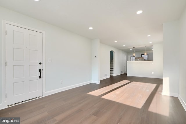 unfurnished living room featuring dark hardwood / wood-style floors