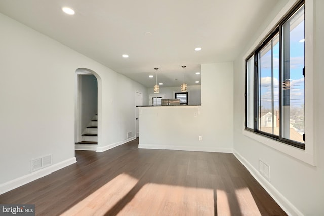 unfurnished living room with dark hardwood / wood-style flooring