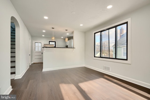 unfurnished living room with dark hardwood / wood-style floors