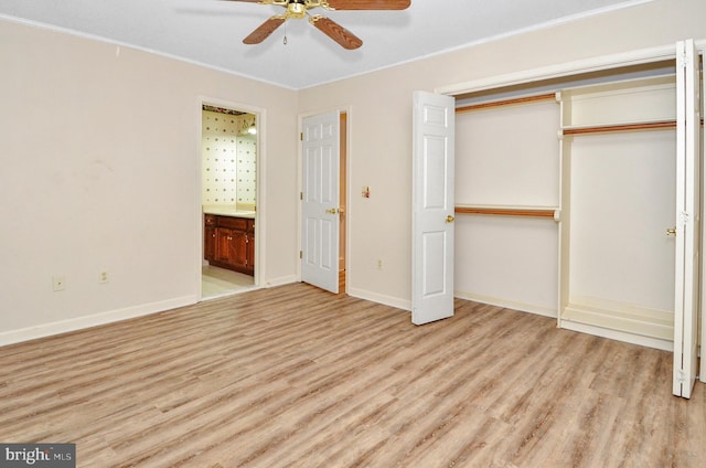 unfurnished bedroom featuring ensuite bathroom, a closet, ceiling fan, and light wood-type flooring