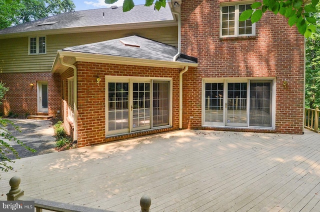 rear view of house featuring a deck