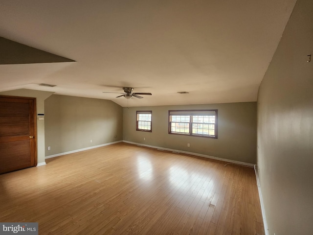 unfurnished room with ceiling fan, light hardwood / wood-style flooring, and lofted ceiling