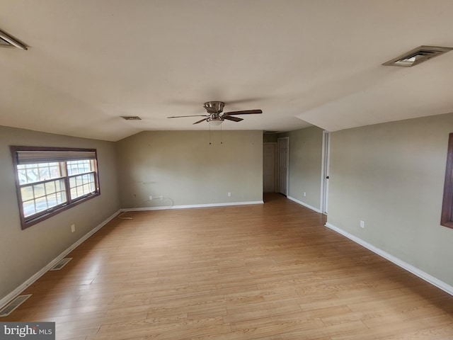 unfurnished room featuring ceiling fan, vaulted ceiling, and light hardwood / wood-style flooring