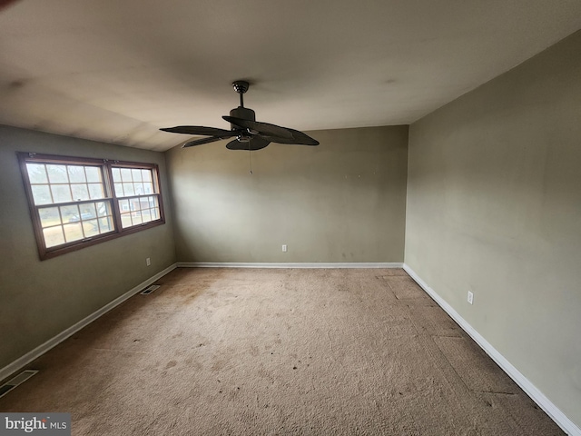 spare room featuring carpet, vaulted ceiling, and ceiling fan