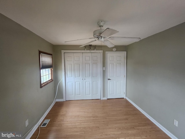 unfurnished bedroom featuring ceiling fan and light hardwood / wood-style flooring