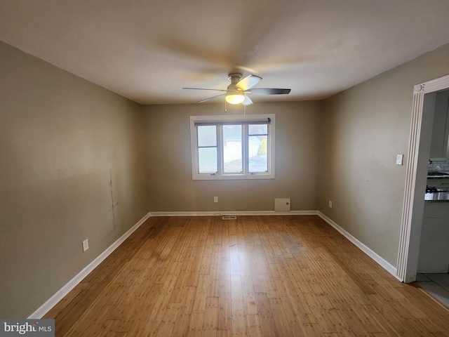 spare room featuring light wood-type flooring and ceiling fan