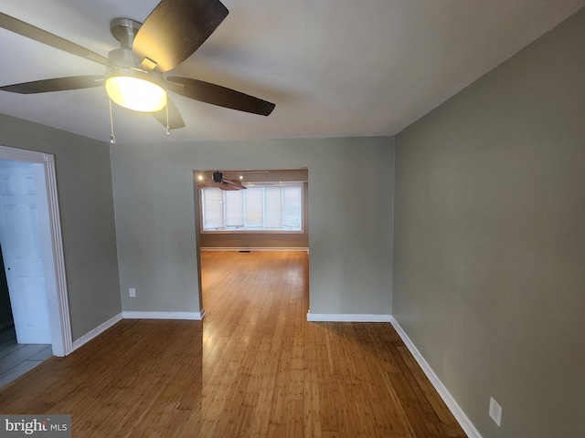 spare room featuring ceiling fan and light wood-type flooring