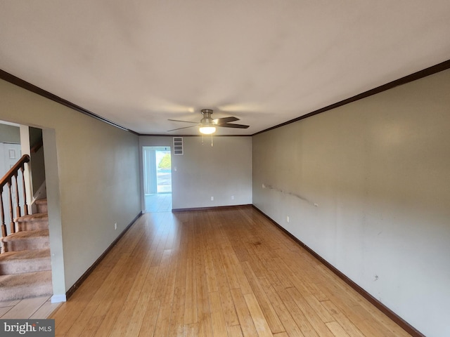 empty room featuring light hardwood / wood-style floors, ceiling fan, and crown molding