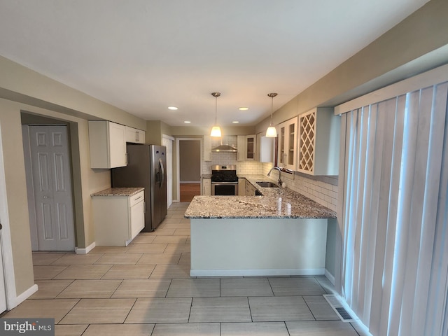 kitchen featuring white cabinets, light stone countertops, decorative light fixtures, kitchen peninsula, and stainless steel appliances