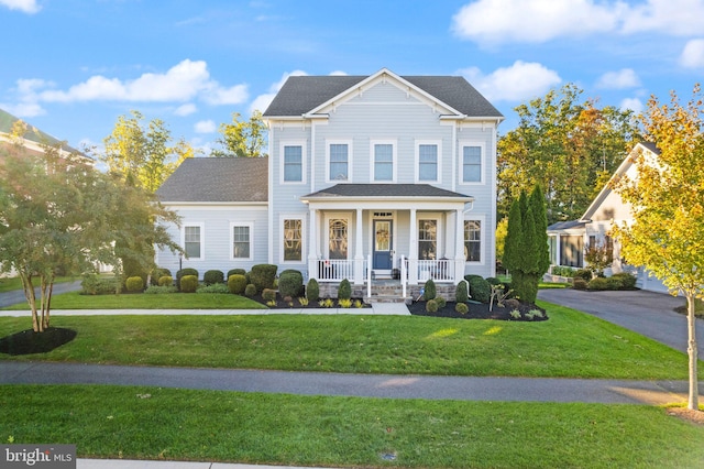 view of front of property featuring covered porch and a front yard