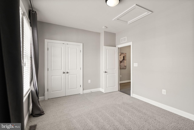 unfurnished bedroom with carpet flooring and a closet