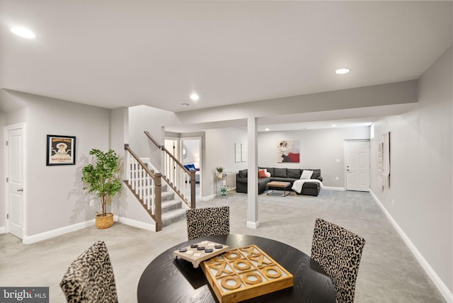 dining space featuring light carpet