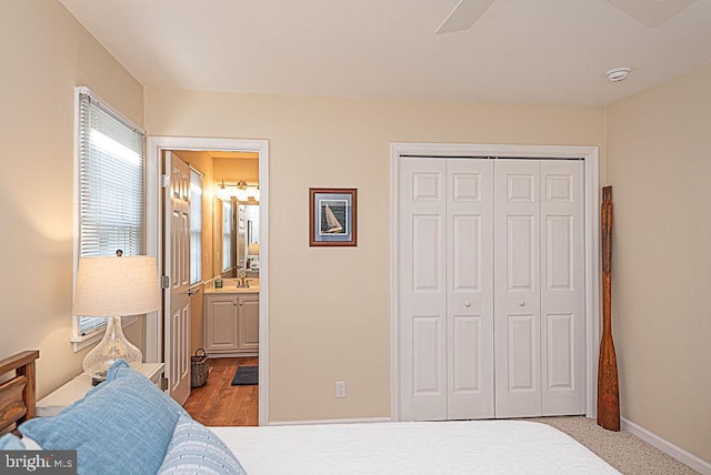 bedroom featuring a closet, ceiling fan, and ensuite bathroom