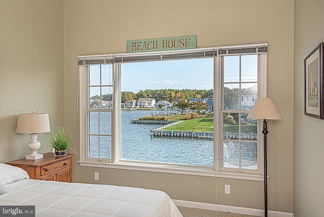 carpeted bedroom featuring a water view