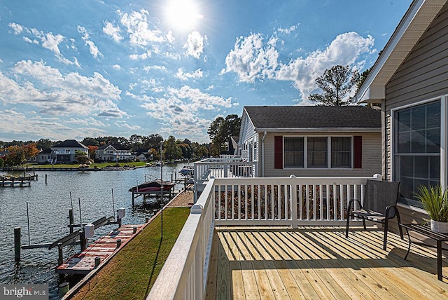 wooden deck featuring a dock and a water view