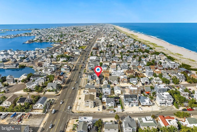 aerial view with a beach view, a water view, and a residential view