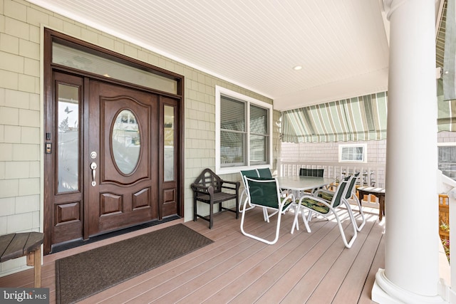 view of exterior entry with a porch