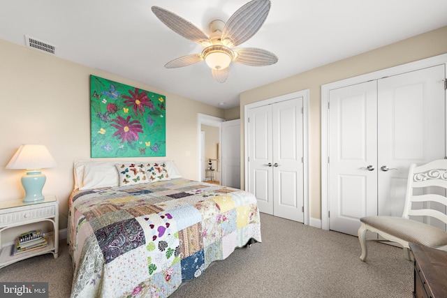 bedroom featuring carpet flooring, two closets, and ceiling fan