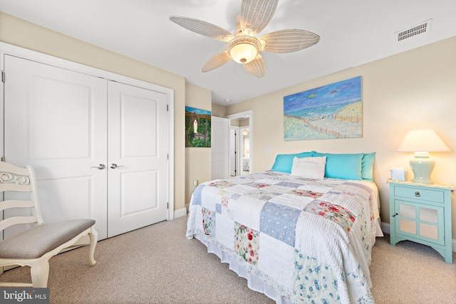 carpeted bedroom featuring ceiling fan and a closet