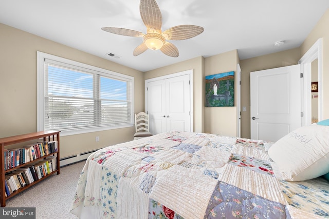 carpeted bedroom featuring ceiling fan and a closet