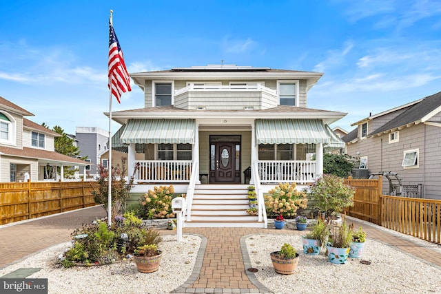 view of front of house featuring solar panels and a porch