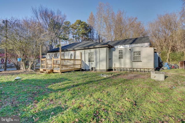 back of house with a lawn and a deck