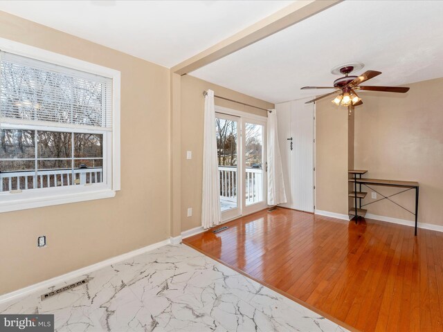 unfurnished room with ceiling fan and wood-type flooring