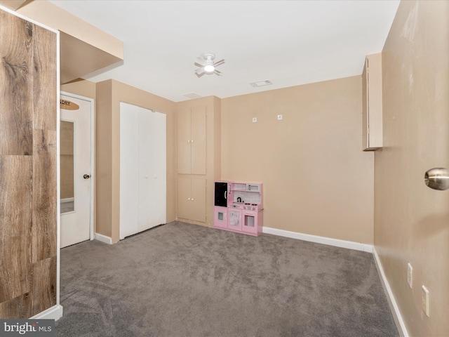 interior space with carpet and ceiling fan