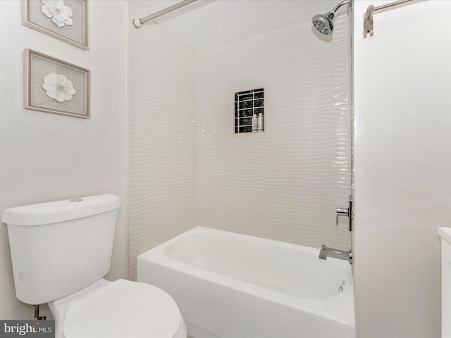 bathroom featuring tiled shower / bath combo and toilet