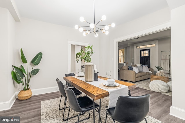 dining area featuring dark hardwood / wood-style floors and a chandelier