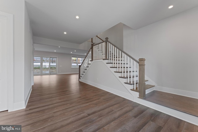 stairway with hardwood / wood-style flooring