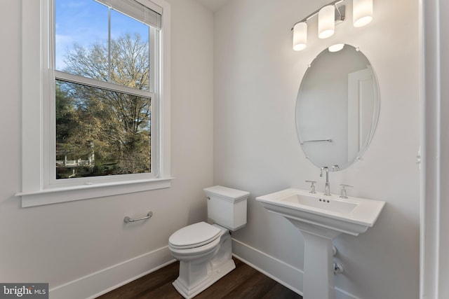 bathroom featuring hardwood / wood-style flooring and toilet