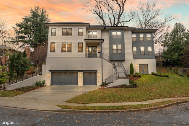 view of front of property featuring a lawn and a garage