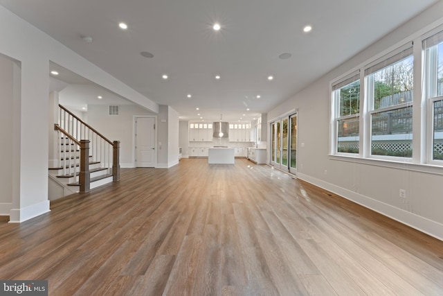 unfurnished living room featuring light wood-type flooring