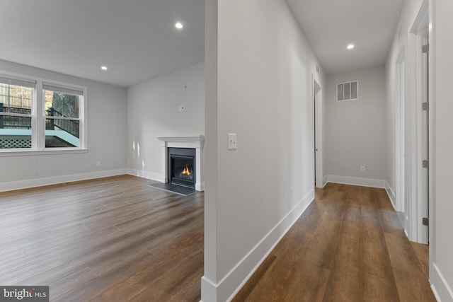 hallway with dark hardwood / wood-style floors