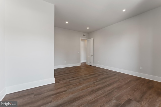 empty room with dark wood-type flooring