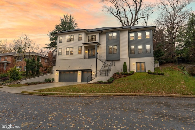 view of front of property with a yard and a garage