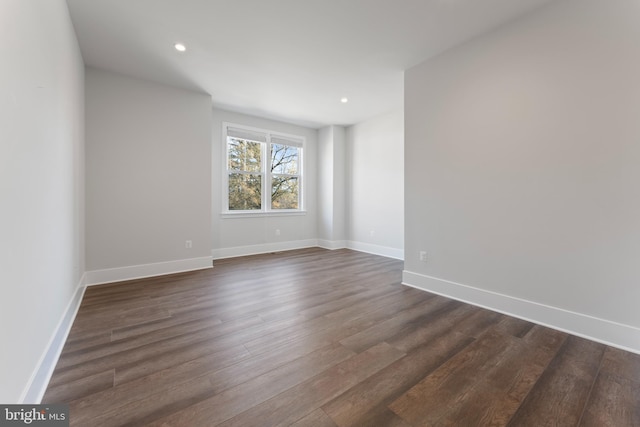 empty room with dark hardwood / wood-style floors