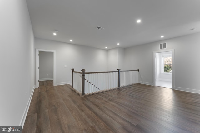 spare room with dark hardwood / wood-style flooring