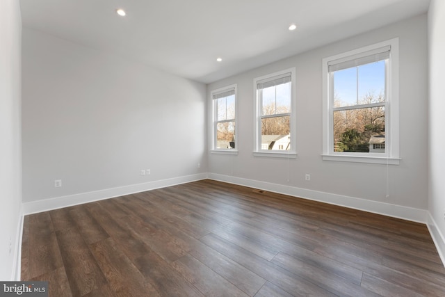 spare room with dark hardwood / wood-style floors